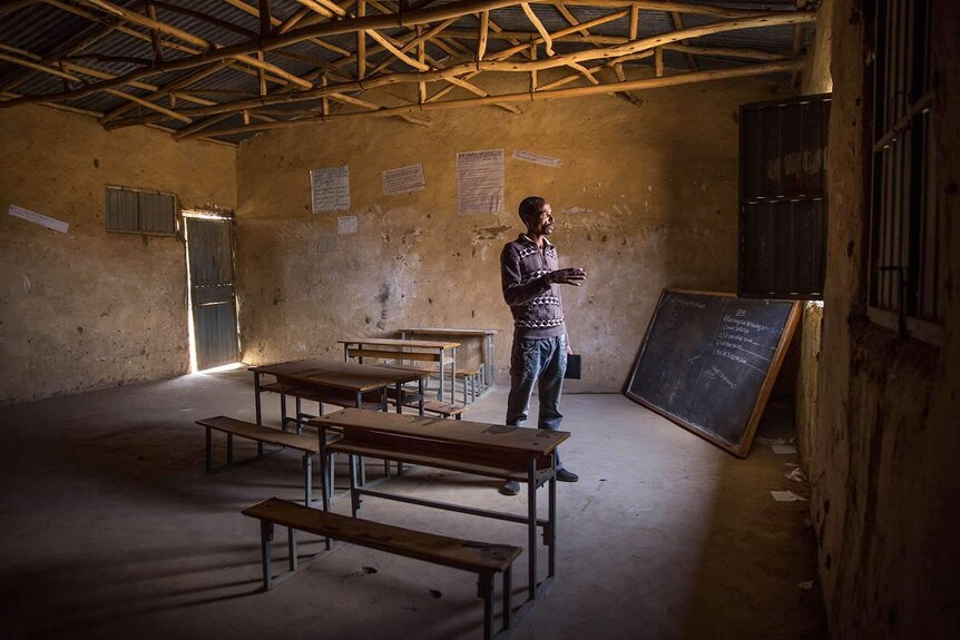 Teacher at empty schoolroom in Ethiopia