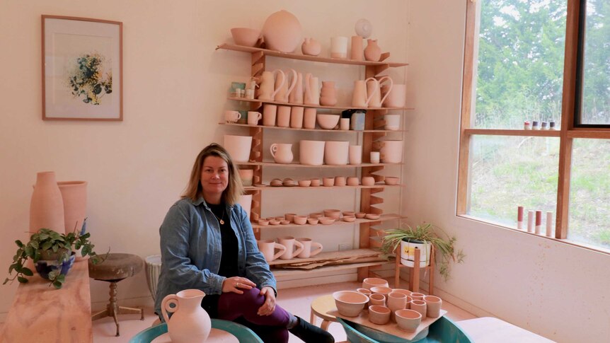 Torquay potter Chela Edmunds sits in her studio space