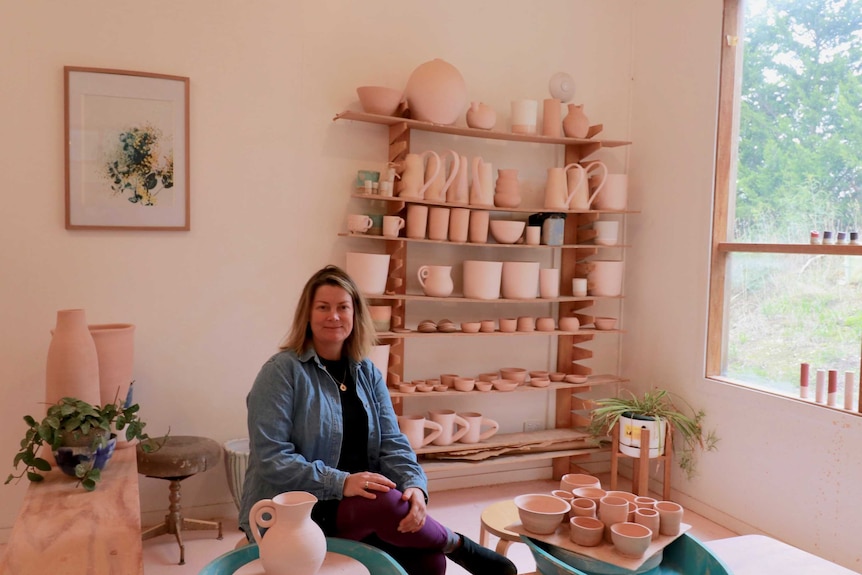 Torquay potter Chela Edmunds sits in her studio space