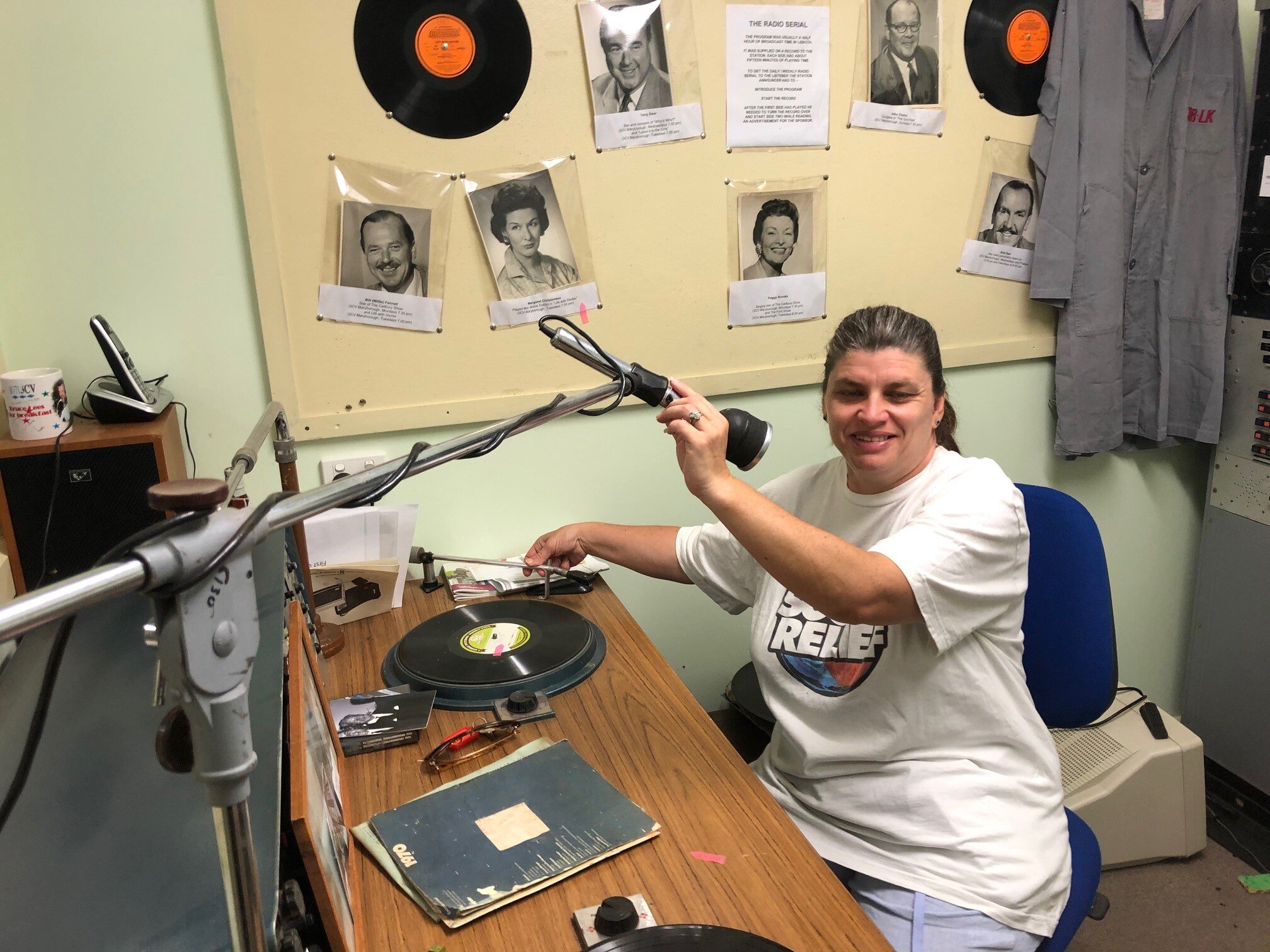 Denise holds microphone in the old 3CV radio studios