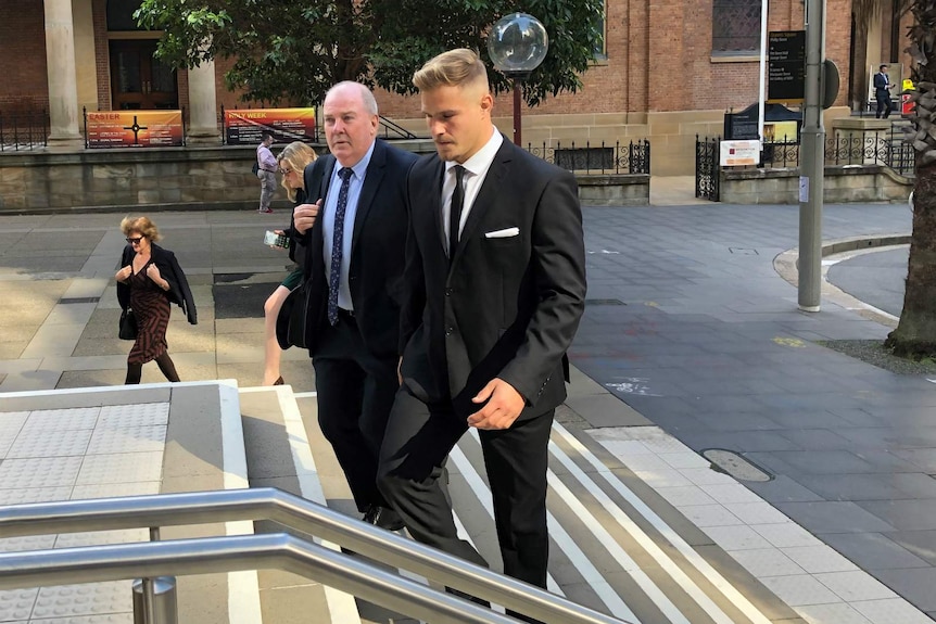 men in suits walking up court steps in sydney