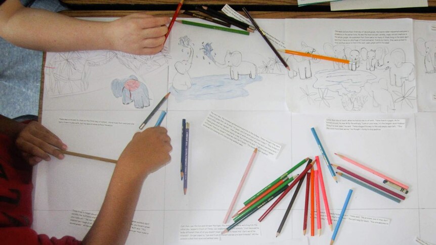 Children drawing elephants with pencils.