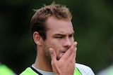 Manly's Brett Stewart with his hand over his mouth at a training session
