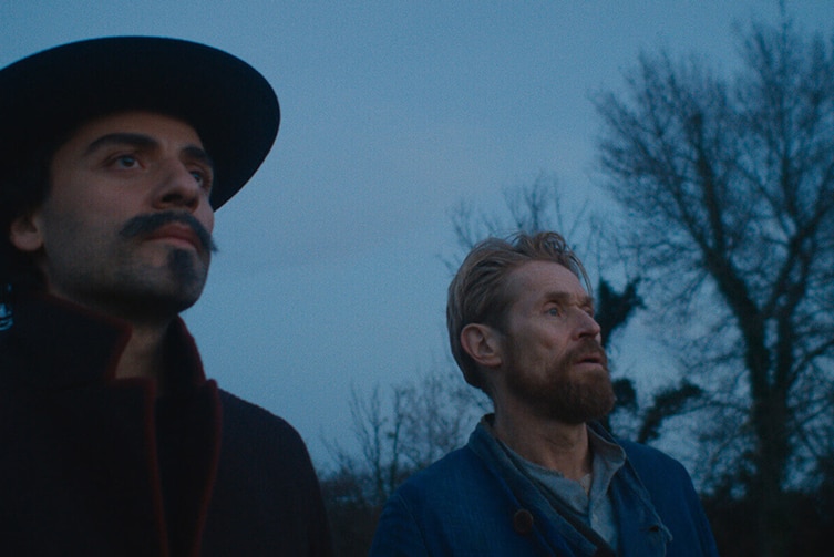 Colour still of Oscar Isaac and Willem Dafoe looking up at the sky in 2018 film At Eternity's Gate.