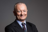 ABC election analyst Antony Green stands with his arms folded, smiling  in a profile photo