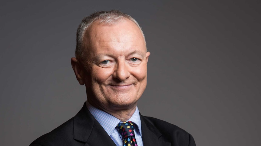 ABC election analyst Antony Green stands with his arms folded, smiling  in a profile photo