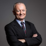 ABC election analyst Antony Green stands with his arms folded, smiling  in a profile photo