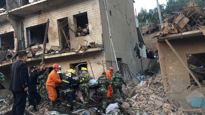 Rescue workers search at site after an explosion hit.