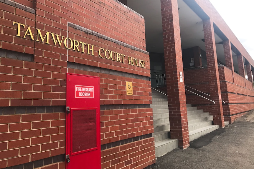 Red brick building with lettering saying, 'Tamworth Court House' signage out the front, stairs to the right up into the building