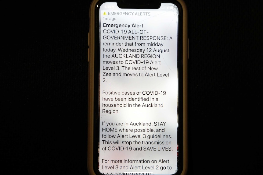 A news alert is displayed on a mobile phone in Christchurch, New Zealand