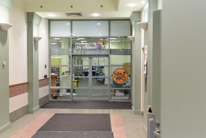 The entrance to a building with signs for Melbourne City Mission and Frontyard.