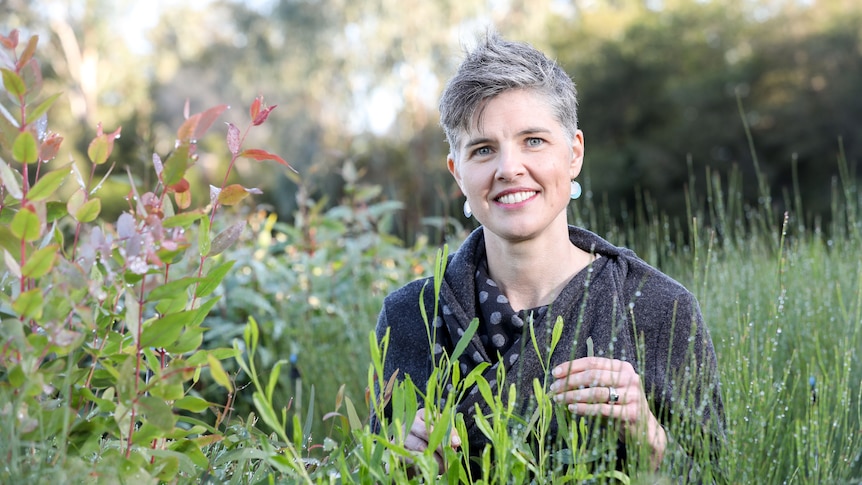 woman standing amongst green nature