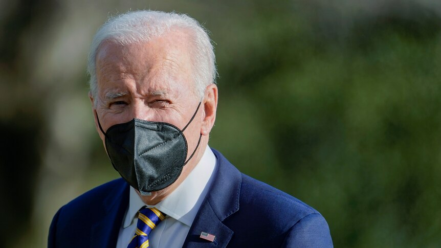 Close up of President Joe Biden wearing black face mask.