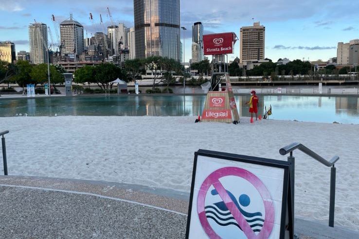 Lifeguard at empty beach at Streets Beach at South Bank in Brisbane CBD during a coronavirus lockdown