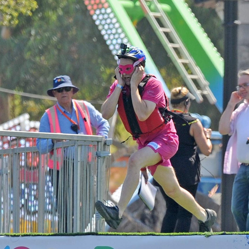 Samuel Johnson runs towards the Yarra River as part of the Birdman Rally.