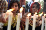 Pakistani civil society activists light candles during a rally in Karachi on December 23, 2014, held in solidarity with the victims of the Peshawar school massacre.