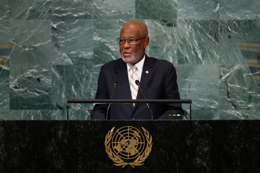 Jean Victor Geneus in a suit speaks at the United Nations General Assembly