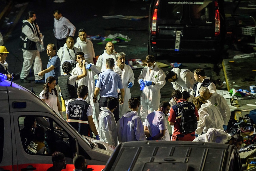 People gather near ambulance at site near Turkish airport explosion