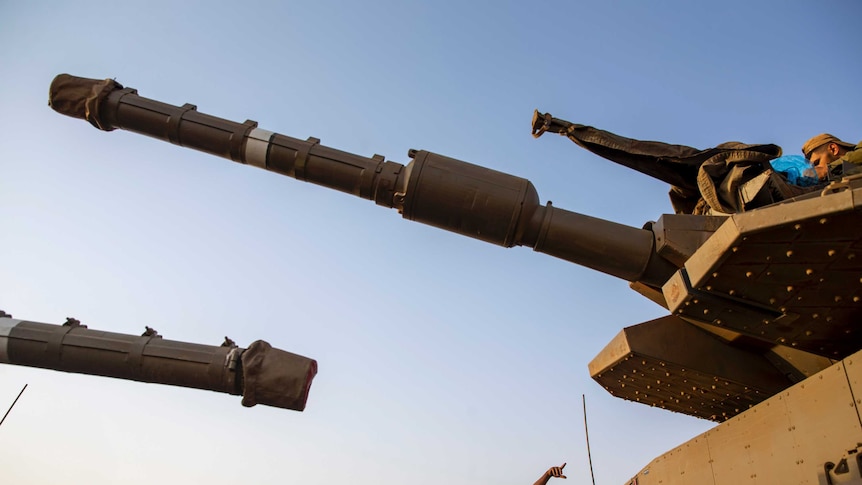 Israeli soldiers work on tanks in the Israeli-controlled Golan Heights near the border with Syria.