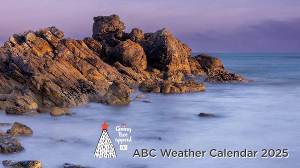 Beach water and rocks with sunset sky in background