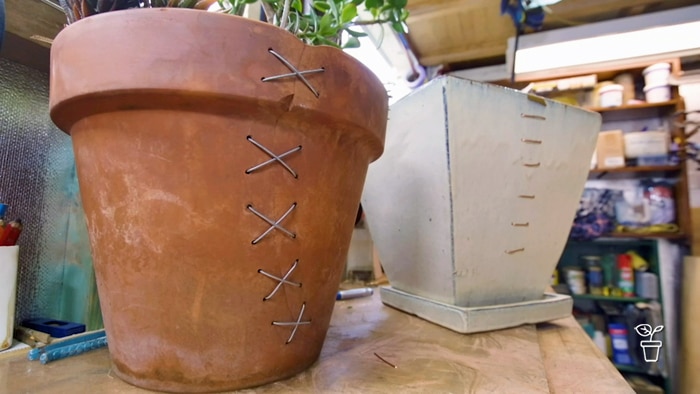 2 repaired pits sitting on a bench in a work shed