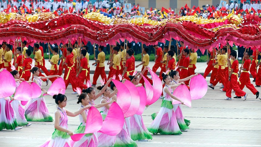 Vietnamese children perform dances representing the dragon and the lotus.