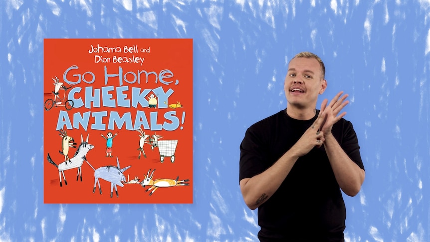 Auslan presenter Kirk O'Meara-Presley stands beside image of book,  Go Home, Cheeky Animals