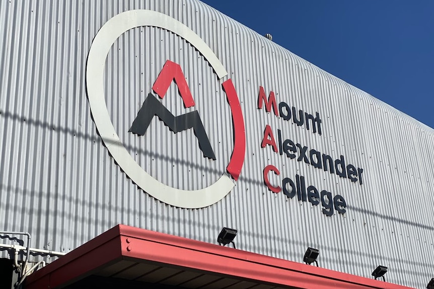 A corrugated metal exterior wall of Mount Alexander College with the school's name emblazoned on the side.