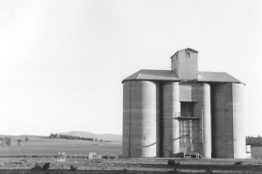 Black and white photograph of an old concrete silo