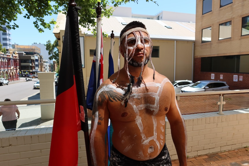 An Indigenous man with ceremonial headband.