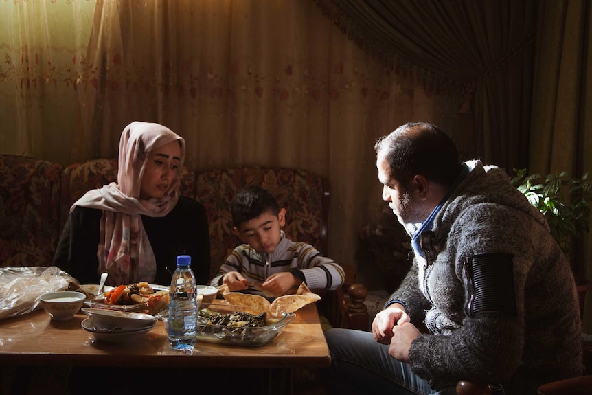 Imad Awad having a meal with his family.