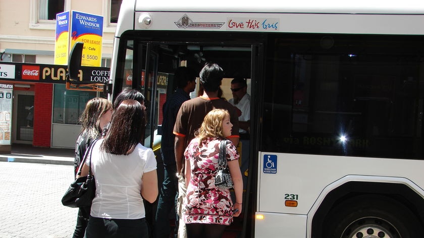 Tasmanians queue for the bus.