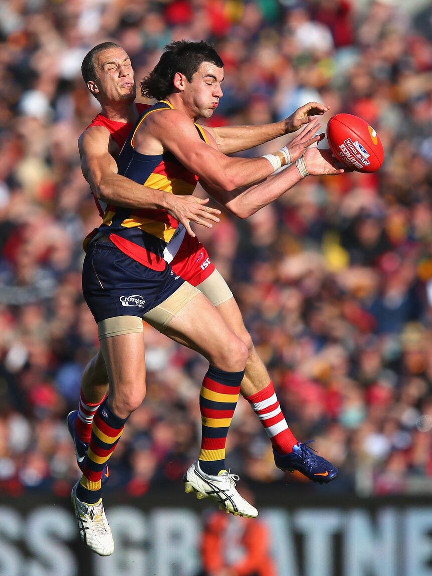 Sydney defender Ted Richards shuts down a chance for Adelaide's Taylor Walker