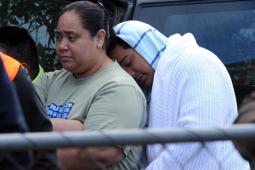 House fire survivor Misi Matauaina mourns at the scene in Kingston