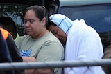 House fire survivor Misi Matauaina mourns at the scene in Slacks Creek