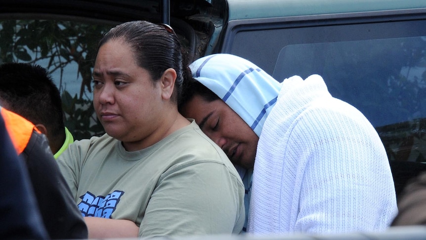 House fire survivor Misi Matauaina mourns at the scene in Slacks Creek