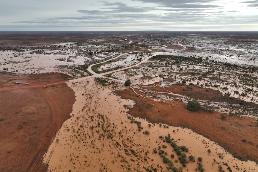 Muddy water covers land at Allandy Station in far west NSW. 