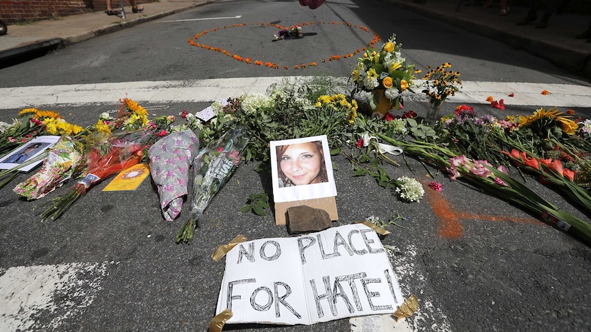 Flowers surround a photo of 32-year-old Heather Heyer, who was killed when a car hit a crowd of protesters in Charlottesville.