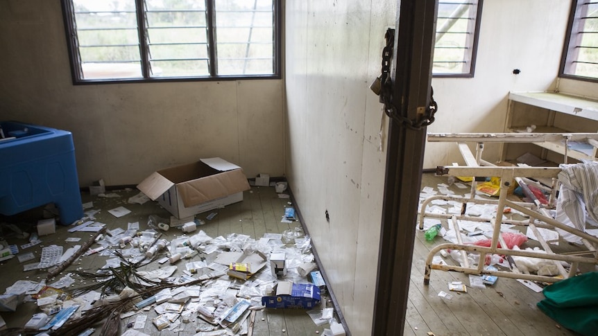 Discarded boxes of medication cover the floor of an abandoned health clinic in Tukupangi, PNG, destroyed in tribal fighting.