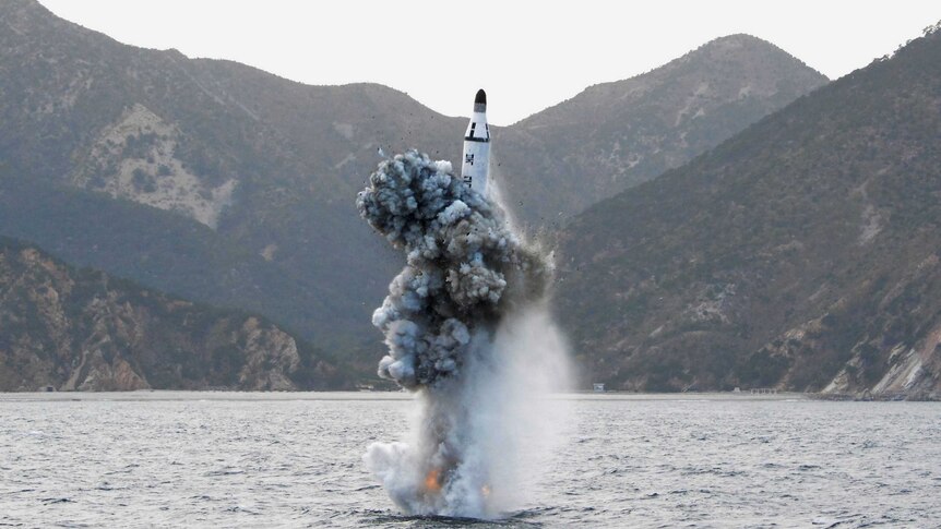 A ballistic missile launches out of the water.