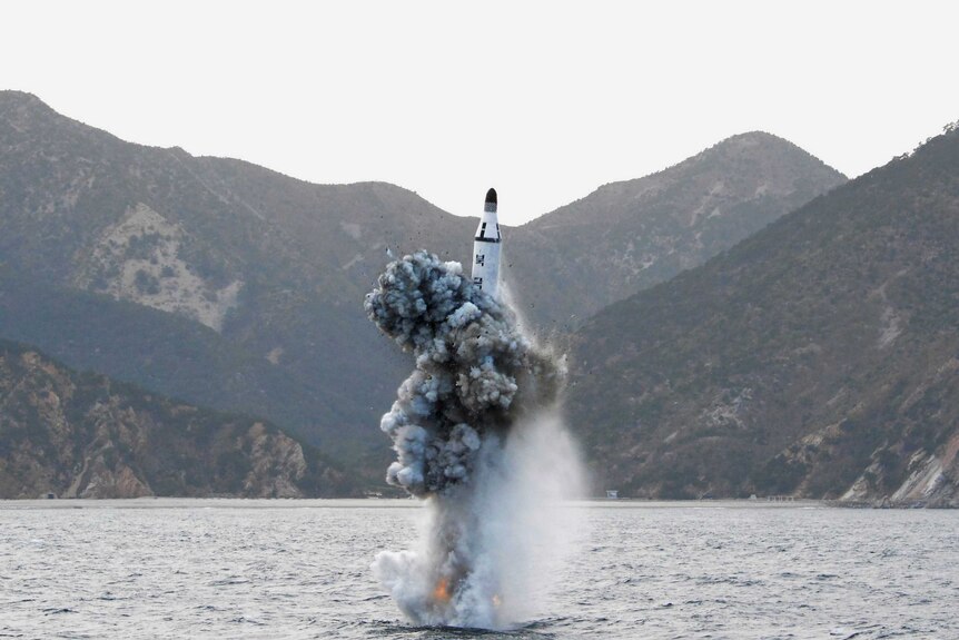 A ballistic missile launches out of the water.