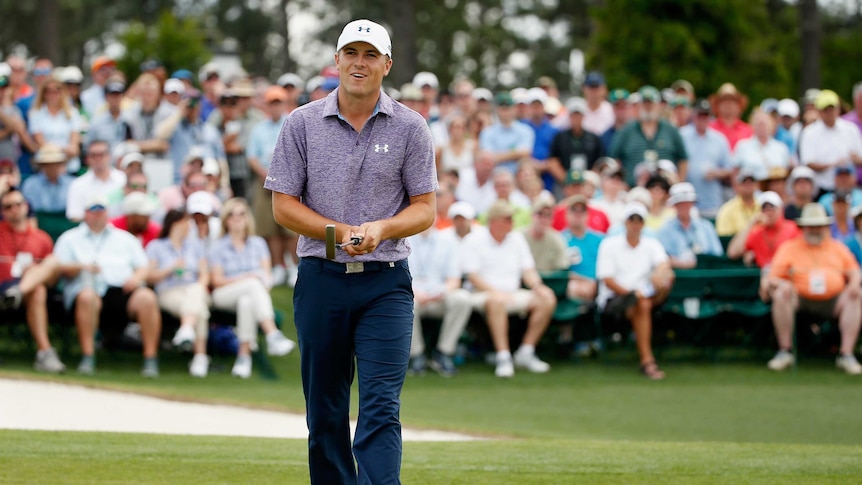 Runaway leader ... Jordan Spieth reacts to a putt on the 18th green