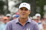 Runaway leader ... Jordan Spieth reacts to a putt on the 18th green