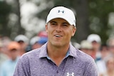 Runaway leader ... Jordan Spieth reacts to a putt on the 18th green