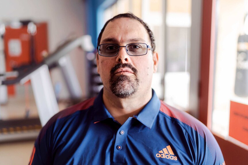 A man with a goatee, wearing glasses.