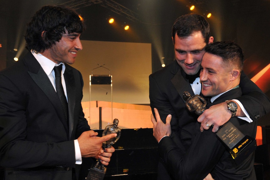 2013 Dally M medallist Cooper Cronk (R) is congratulated by Cameron Smith and Johnathan Thurston.