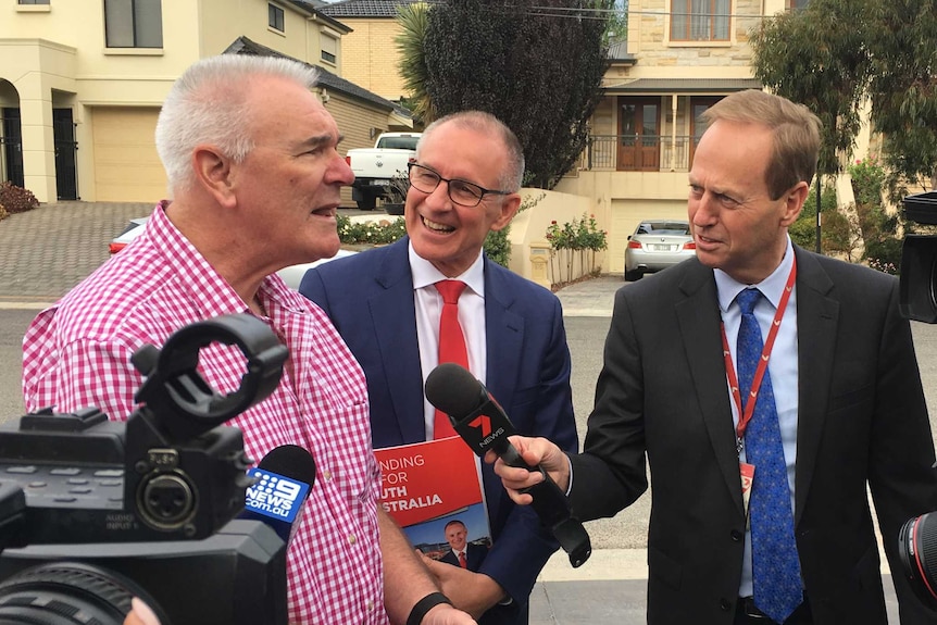 Resident Geoff Perkins alongside Premier Jay Weatherill chats to a media pack