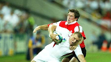 Mike Tindall is tackled by Shane Williams during the Rugby World Cup