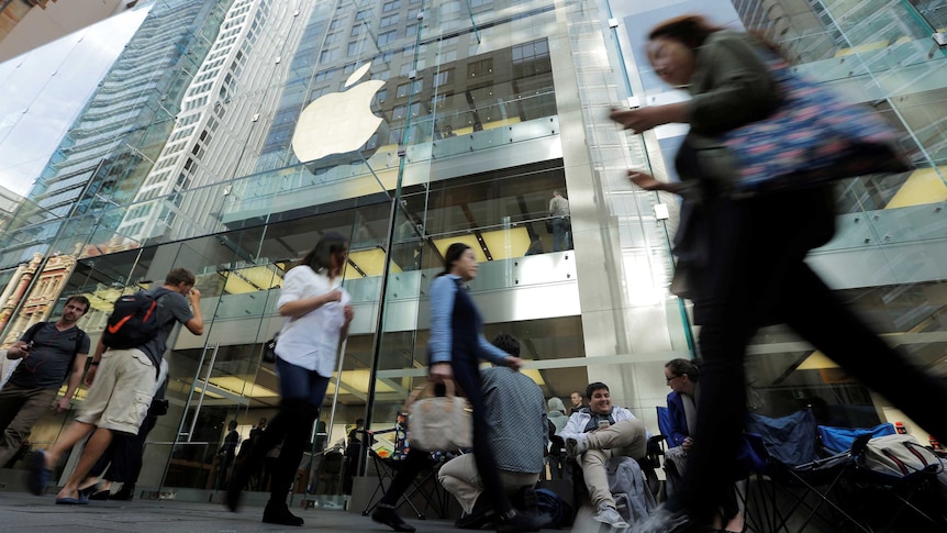 Pedestrians pass by the Apple Store in Sydney.