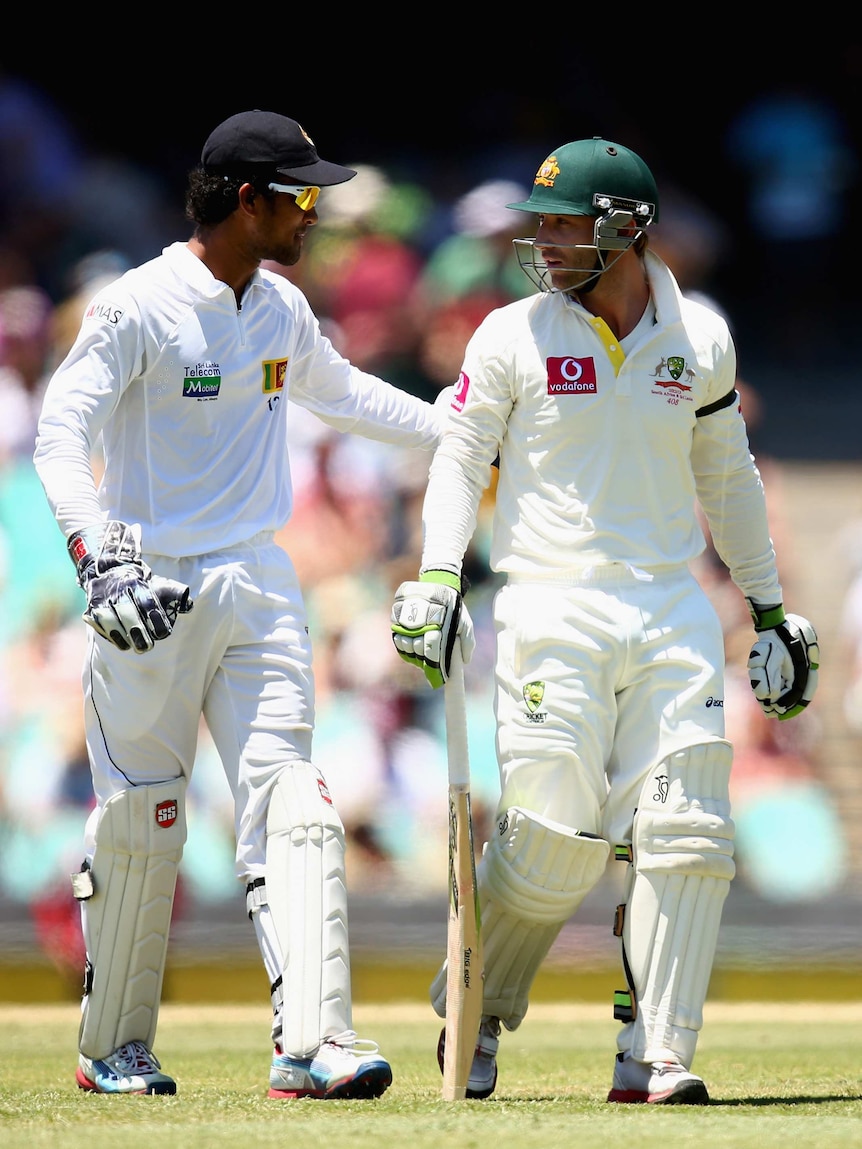 Sharing some words ... Dinesh Chandimal exchanges pleasantries with Phillip Hughes.